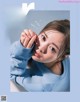 A magazine cover with a young woman in a blue sweatshirt.