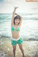 A woman in a bikini standing in the ocean.