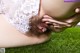 A woman in a white lingerie laying on the grass.