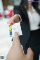 A woman holding a business card in her hand.