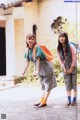 A couple of young women standing next to each other.