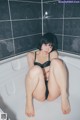 A woman sitting in a bathtub with her legs crossed.