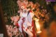 A woman in a red and white kimono posing for a picture.