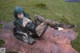 A woman laying on top of a cowhide rug in the grass.