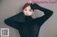 a woman in a black turtle neck sweater posing for a picture