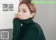 a woman in a green turtle neck sweater posing for a picture