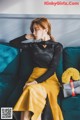 a woman sitting on top of a blue couch