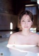 A woman in a white bathing suit in a pool.