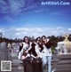 A group of young women posing for a picture in front of a statue.