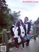 A group of young women standing next to each other on a bridge.