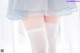 A close up of a woman's legs wearing white stockings.