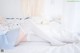 A woman laying on a bed wearing white stockings.