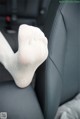 A pair of white socks sitting on top of a car seat.