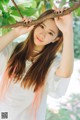 A woman with long brown hair is posing for a picture.