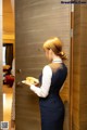 A woman holding a plate of food in front of a door.