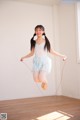 A young girl jumping with a skipping rope.