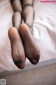 A close up of a woman's feet in black stockings.