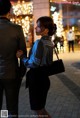 A man and a woman standing next to each other on a sidewalk.