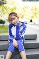 A young woman sitting on the steps of a building.