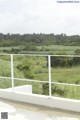 A balcony with a view of a green field.