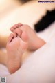 A close up of a baby's feet on a bed.