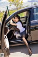 A woman sitting in the driver's seat of a car.