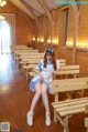 A woman sitting on a bench in a church.