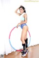 A woman in a blue bikini with a hula hoop.