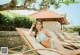 A woman in a blue bikini laying on a lounge chair.