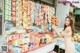 A woman standing in front of a display of snacks.