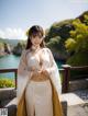 A woman in a white and yellow kimono posing for a picture.