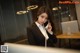 A woman in a business suit talking on a phone.