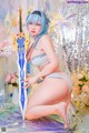 A woman in lingerie posing with a sword.